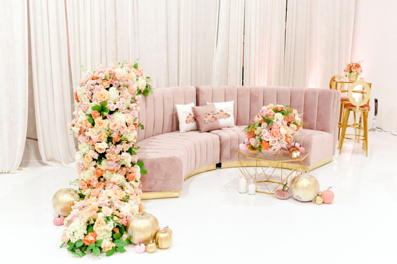 pink velvet couch and abundance of florals for girl baby shower decor