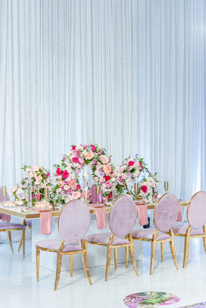 Dusty pink velvet chairs with gold legs used for a luxury bridal shower tablescape.