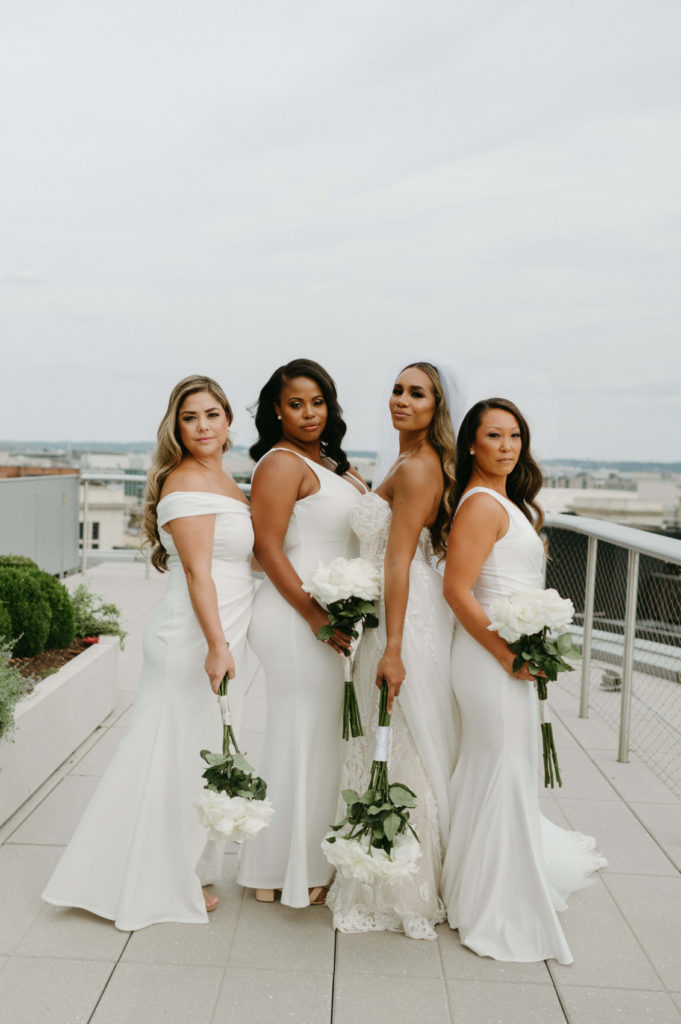 Bride with bridesmaids all in white dresses