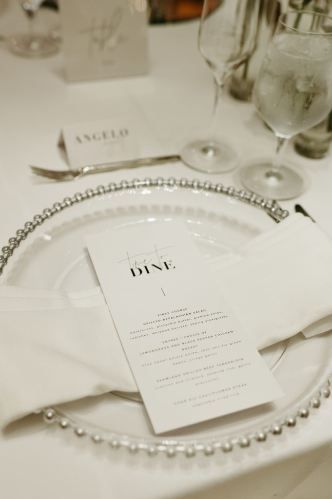 White wedding place setting with a dinner menu