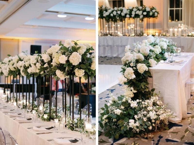 wedding reception decor with tall white and greenery centerpieces