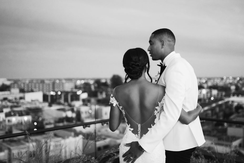 bride and groom toast on rooftop at the Line Hotel in Washington DC