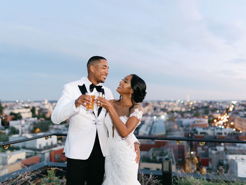 bride and groom toast on rooftop at the Line Hotel in Washington DC