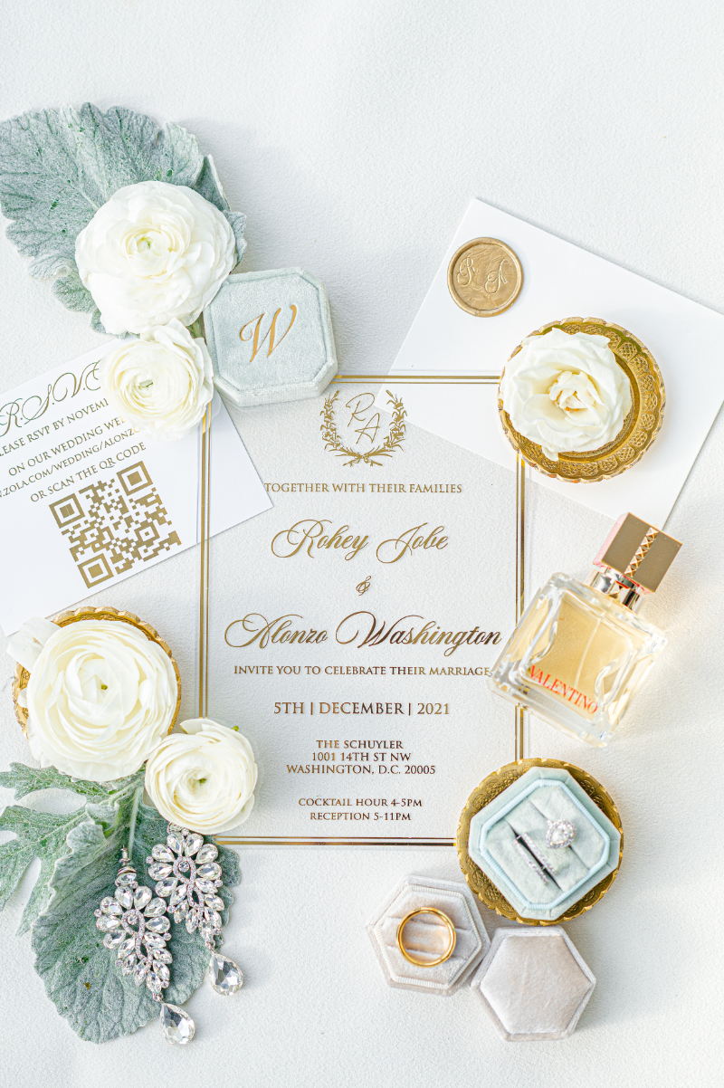 gold and white wedding invitation flatlay of winter wedding details