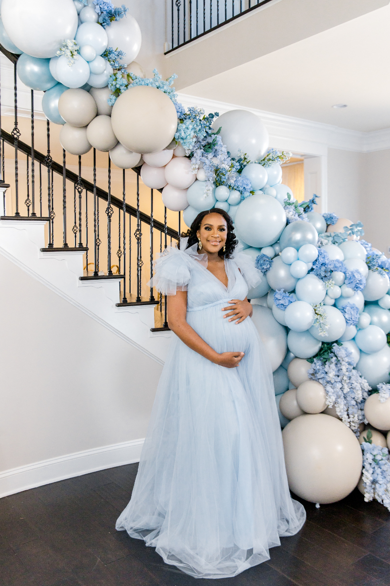 maternity photos in front of decorated staircase