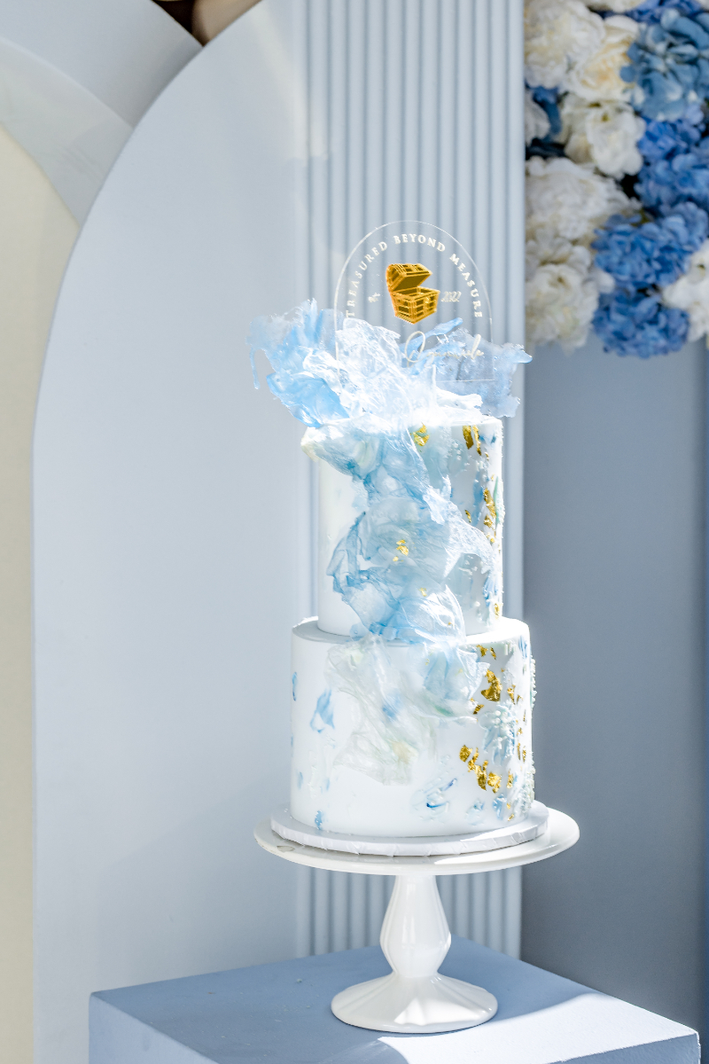 luxury baby shower cake in blue gold and white