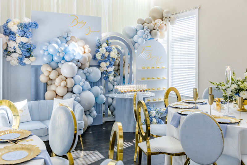 ethereal baby shower decor with flowers, balloons, velvet furniture