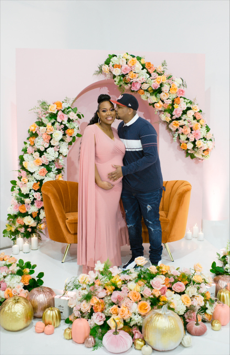 maternity couple photos in front of gorgeous girl baby shower display
