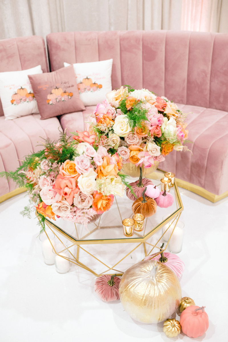 pink velvet couch with fall baby shower decor