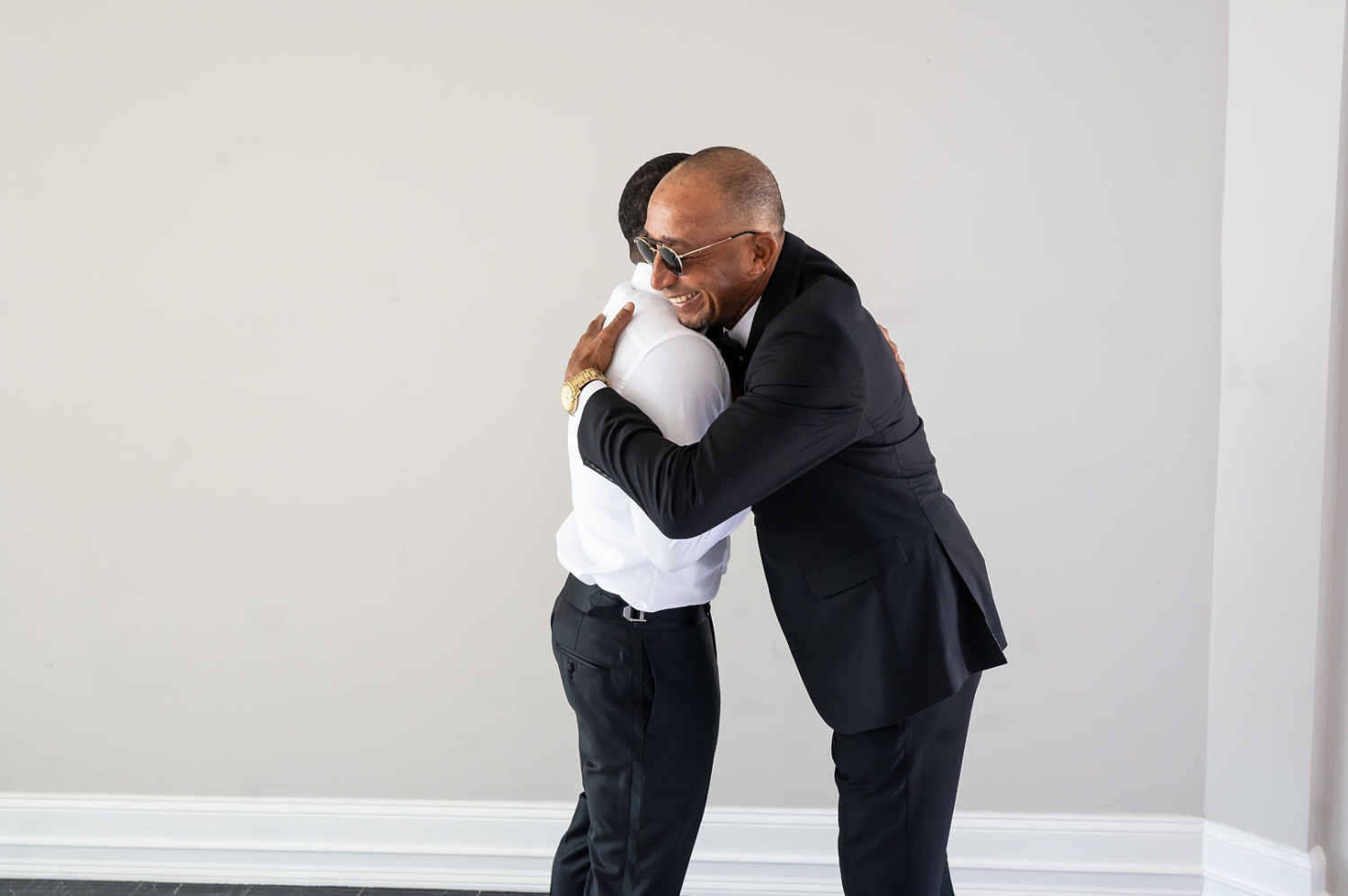 groom hugging dad