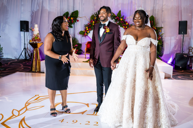 luxury DC wedding planner stands with bride and groom