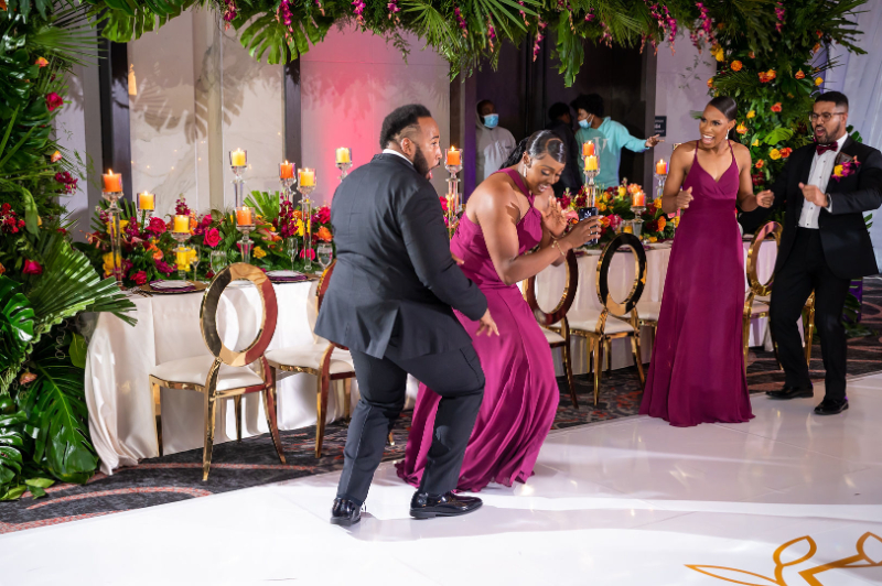 bridesmaid and groomsmen dance into wedding reception