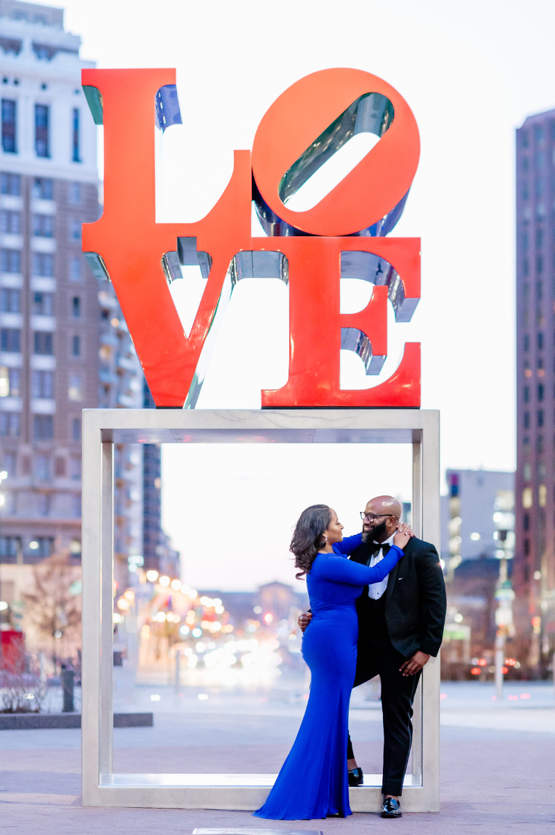 OUTDOOR ENGAGEMENT PHOTO IN FRONT OF BIG 'LOVE' SIGN