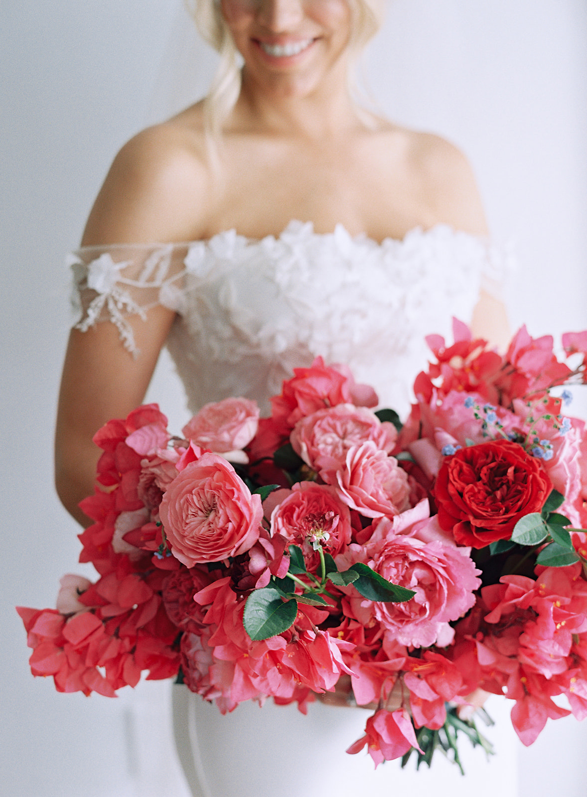 CLOSE UP OF BRIDE HOLDING PINK BRIDAL BOUQUET