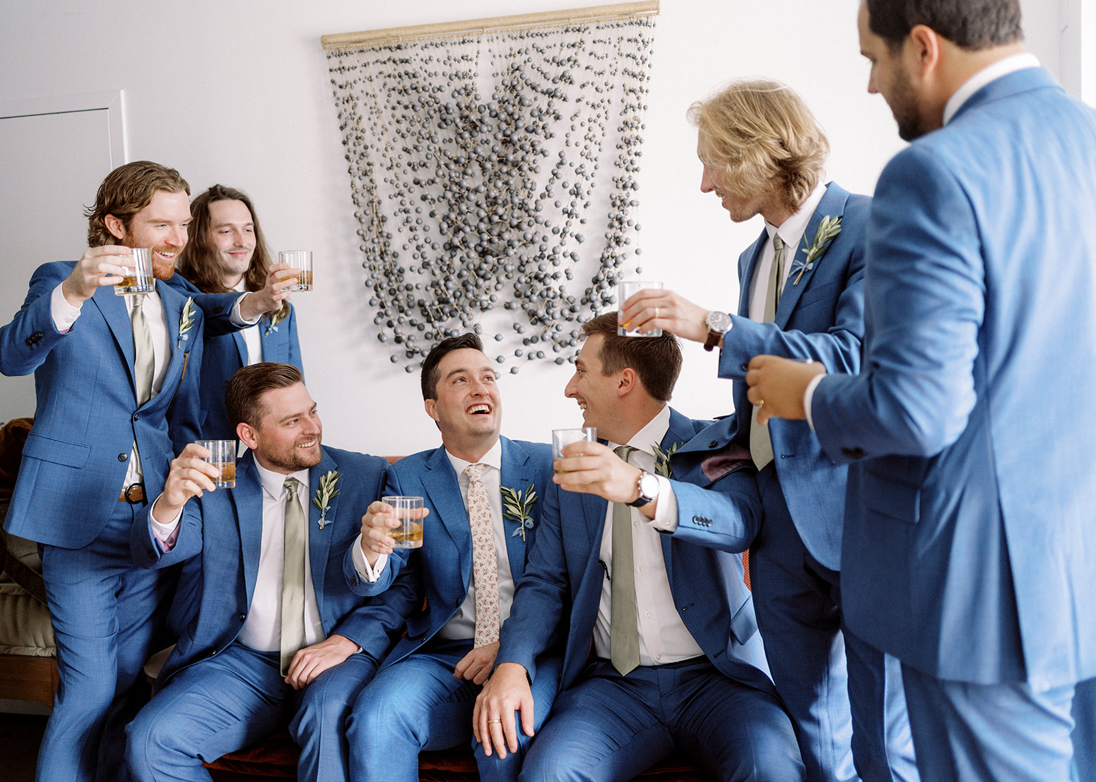 GROOM WITH GROOMSMEN TOASTING EACH OTHER 