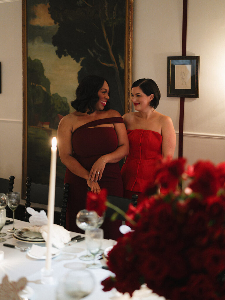 Friends reconnecting around a table dressed in red accents