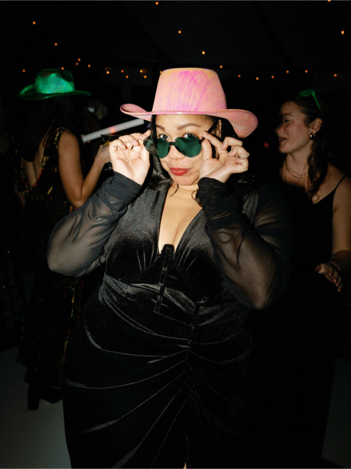 friend of the couple in a pink hat and sunglasses