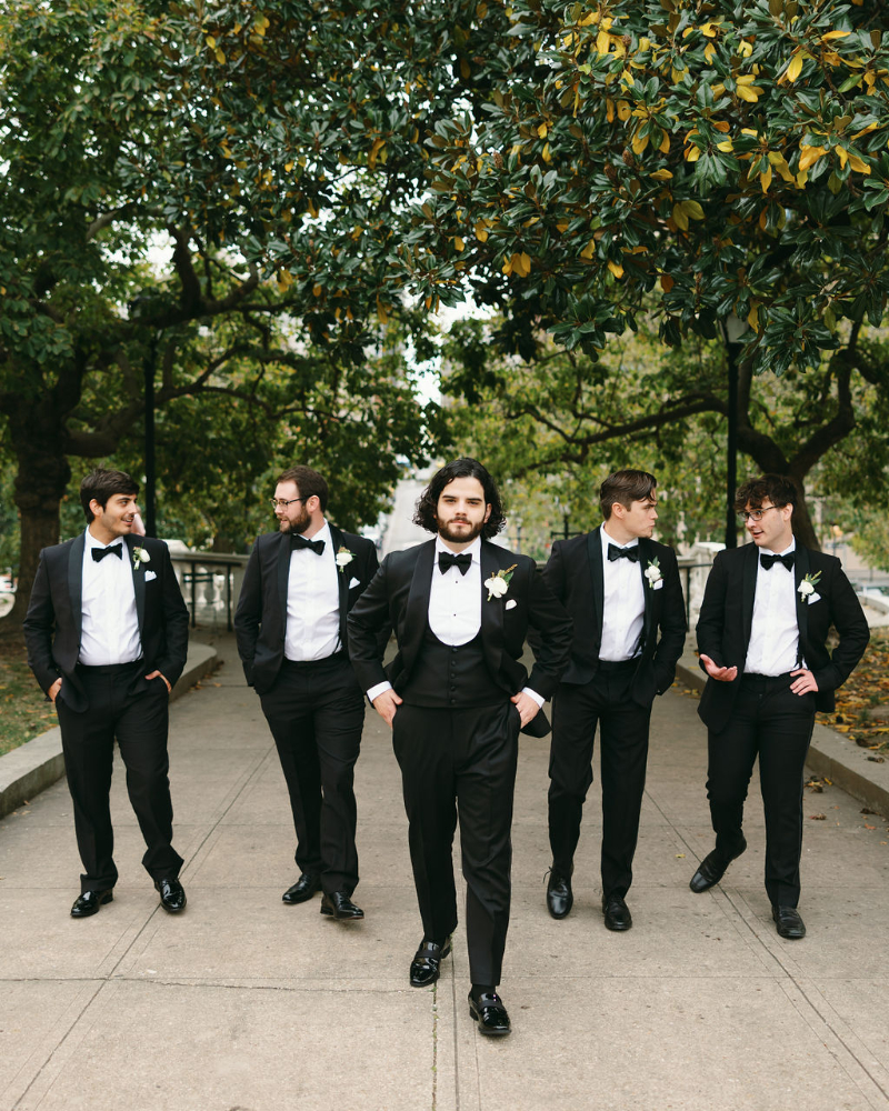 Groomsmen walk toward camera during group portraits