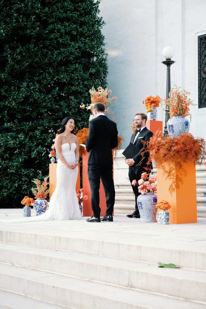 Bride and groom exchange vows during outdoor fall wedding ceremony at Potomac View Terrace. 