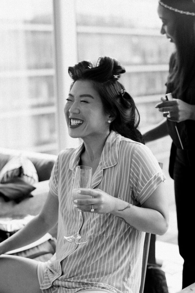 Bride has huge smile on her face as she gets hair and makeup done for wedding at Potomac View Terrace.