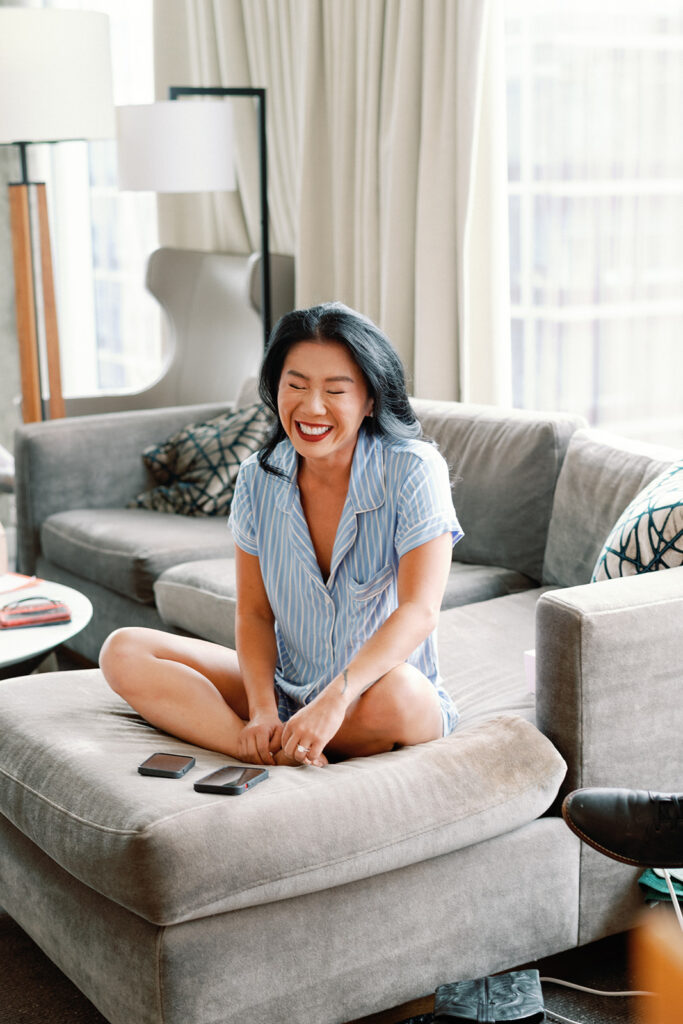 Bride smiles as she finishes getting ready for wedding.