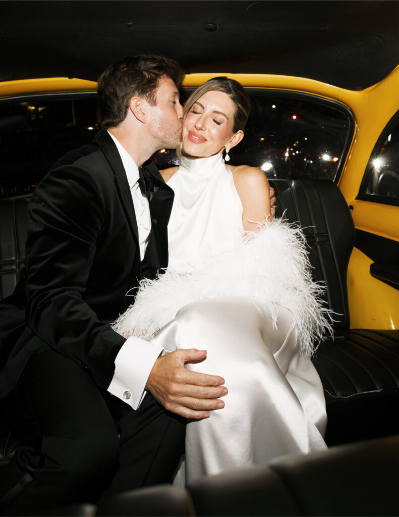 Bride and groom in the back of NYC cab.