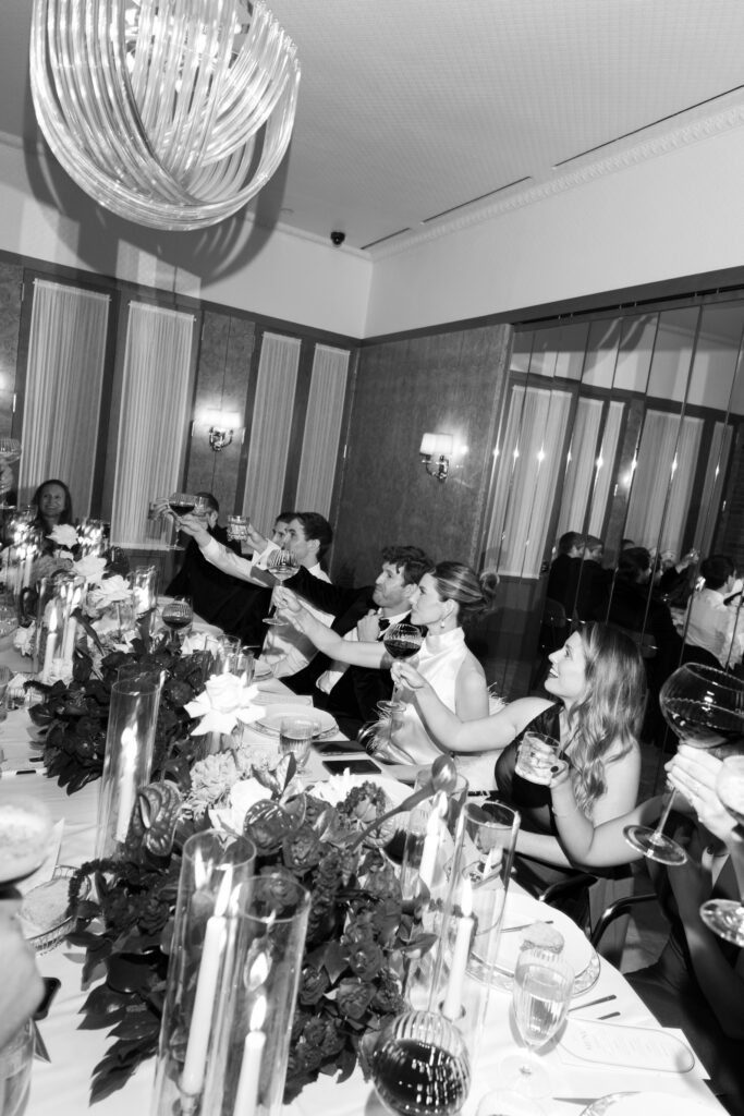 Guests at reception raise glasses for a toast.