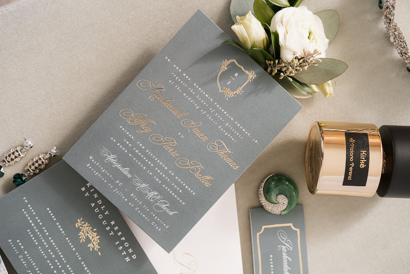 Flat lay of wedding details and invitations for Cosmos Club wedding.