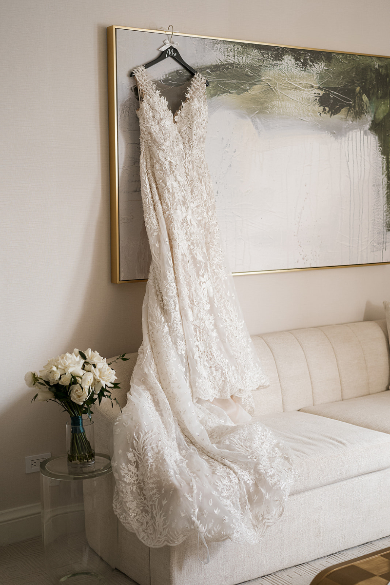 Bride's dress hangs from painting.