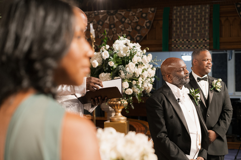 Groom watches in admiration as his bride walks down the aisle.