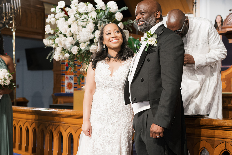 Bride admires her groom once she makes it to the altar during wedding ceremony.
