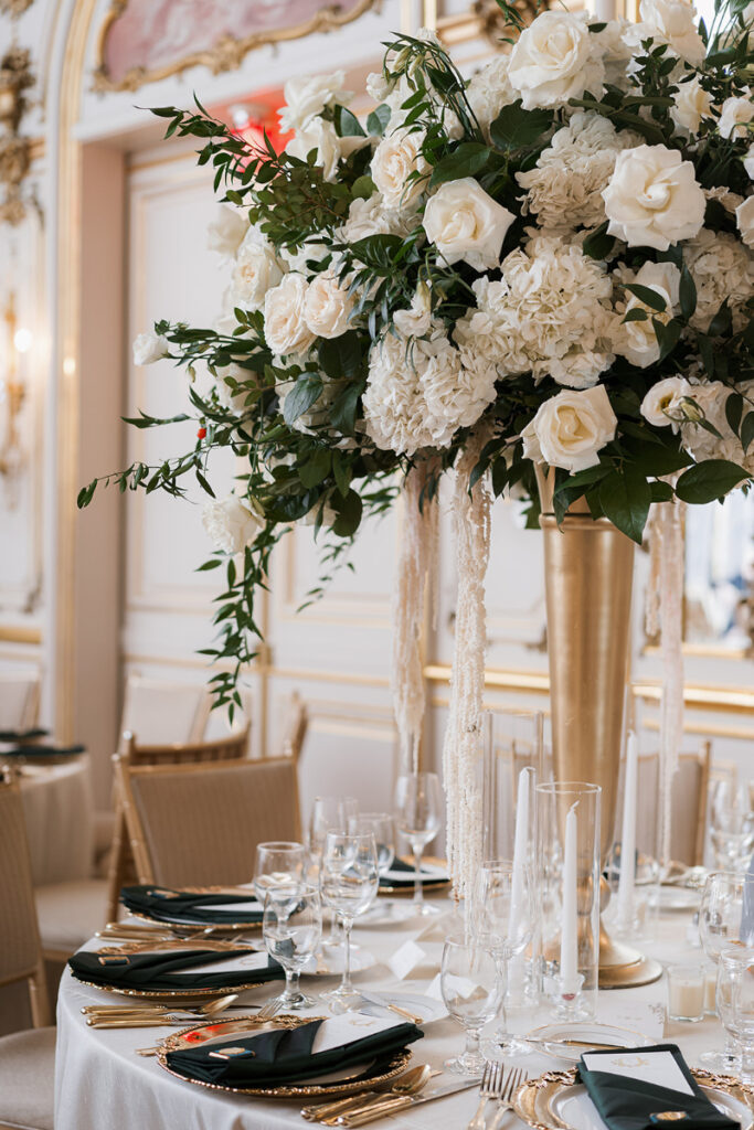 Elevated table settings with lush florals and gold details for Cosmos Club wedding.