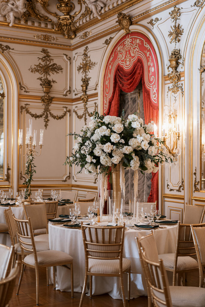 Elevated table settings with lush florals and gold details for Cosmos Club wedding.