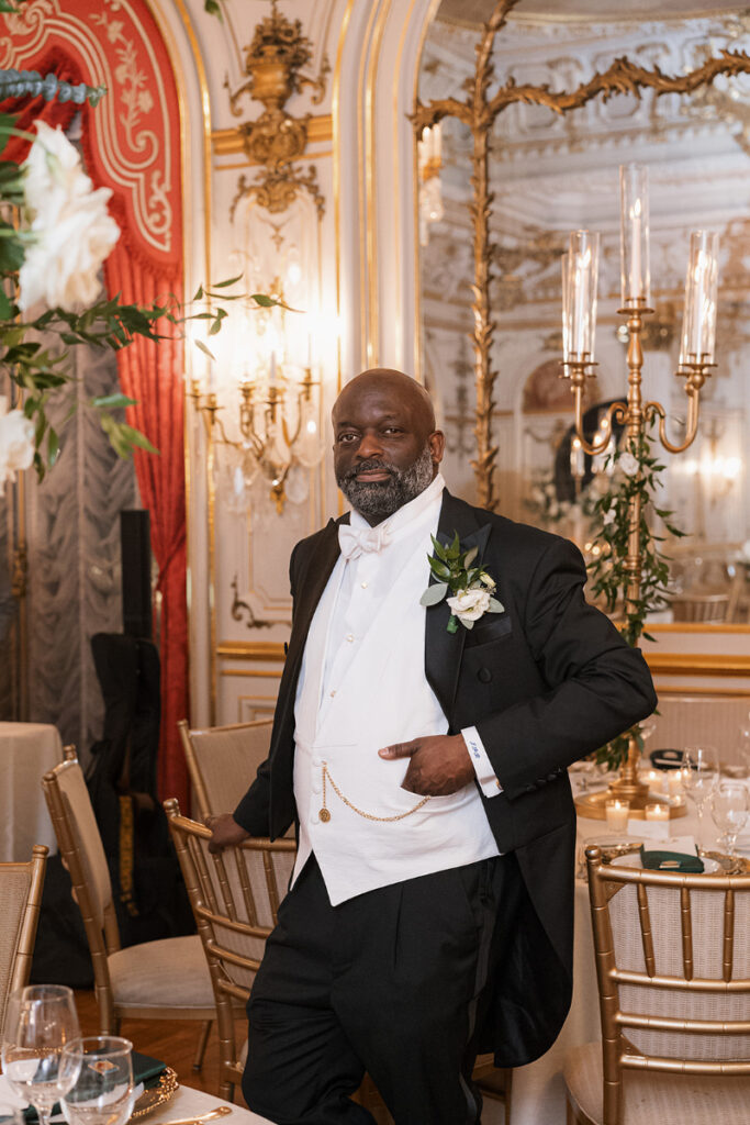 Groom poses for portrait in Cosmos Club.