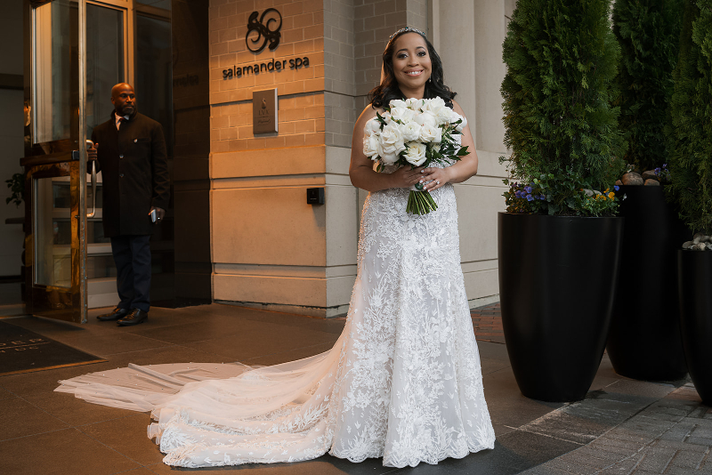 Bride poses for portrait outside of Cosmos Club.