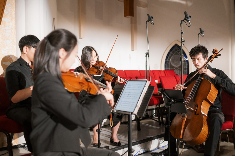 Live music plays as bride walks down the aisle for wedding ceremony.