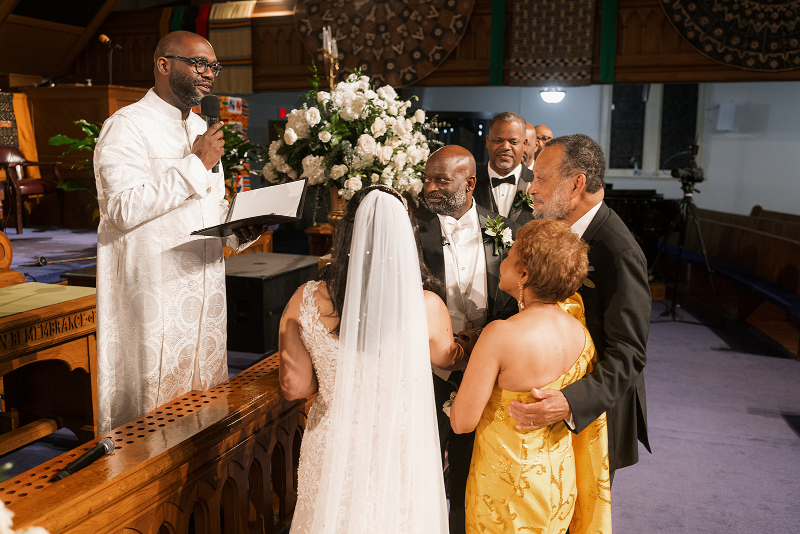 Mother and father give bride away at beginning of wedding ceremony.