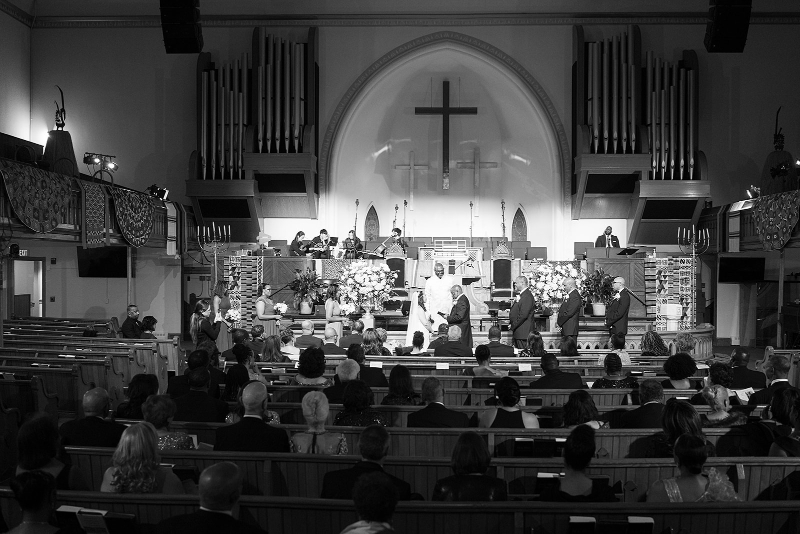 View of entire church during wedding ceremony.