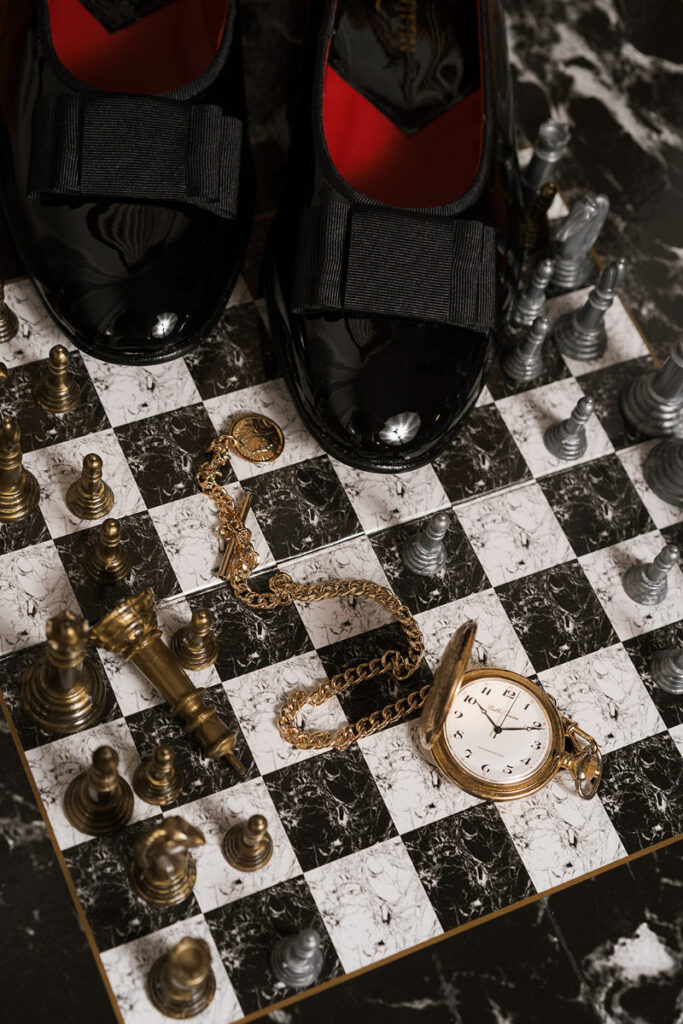 Detail shot of groom's shoes and pocket watch.