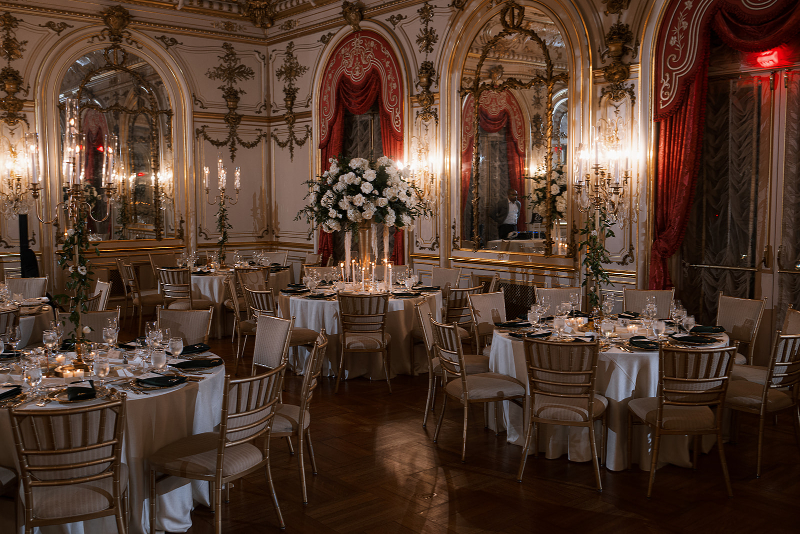 Elevated table settings with lush florals and gold details for Cosmos Club wedding.
