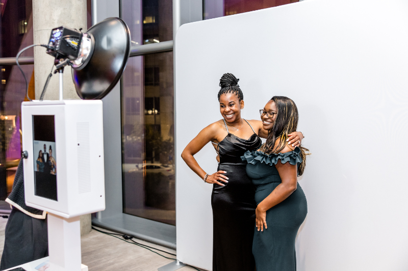 Guests snap photo using photobooth, a perfect example of how corporate event planning makes events seamless.