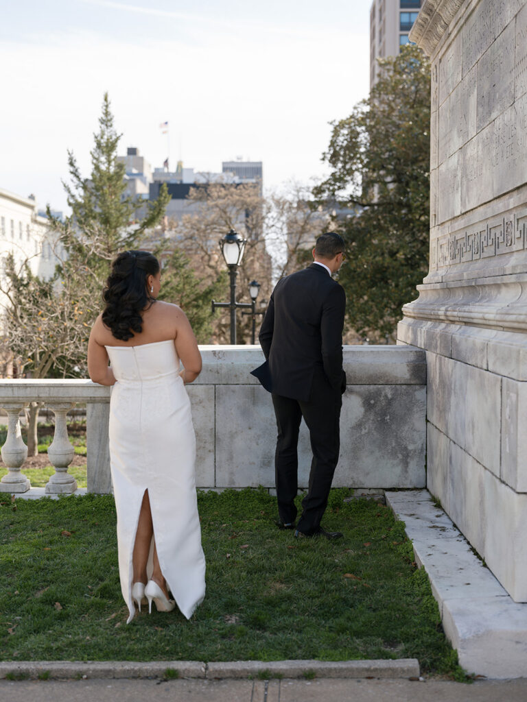 Bride and groom take in the city views together during portraits outside the wedding venue.